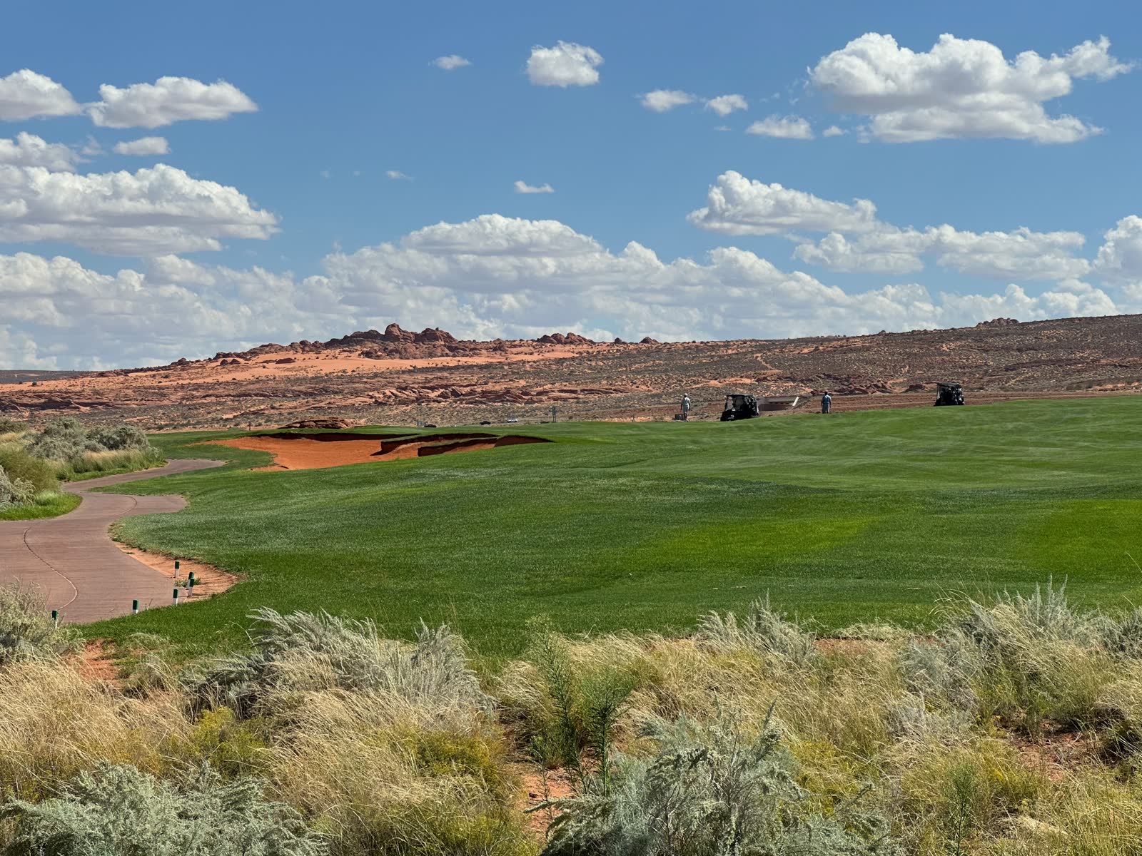 Sand Hollow fairway with a red-sand bunker and desert ridge